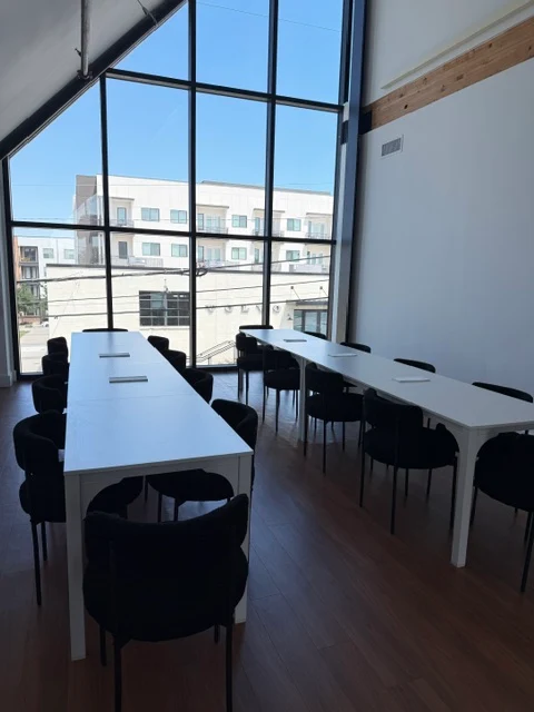 Community seating area at The Brass with large windows